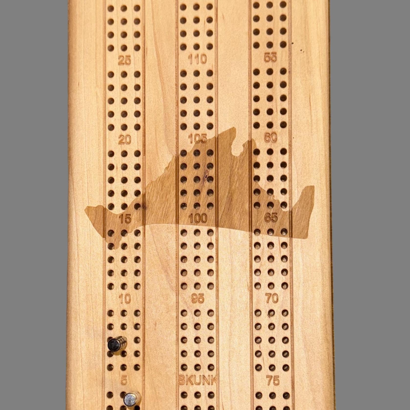 Wooden cribbage board with pegs - close up